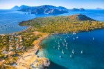 vista aerea di vulcano, con la pozza dei fanghi e le acque calde, la spiaggia di levante, il vulcanello e le barche, sullo sfondo lipari, salina e panarea.