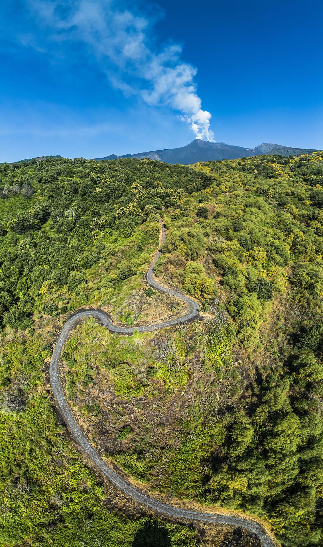 DJI_0744-Pano - Tra boschi e pietra lavica, la strada per Piano Bello sotto il respiro dell'Etna