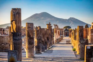 Le colonne del Foro del sito archeologico di Pompei con il cono vulcanico del Vesuvio.
