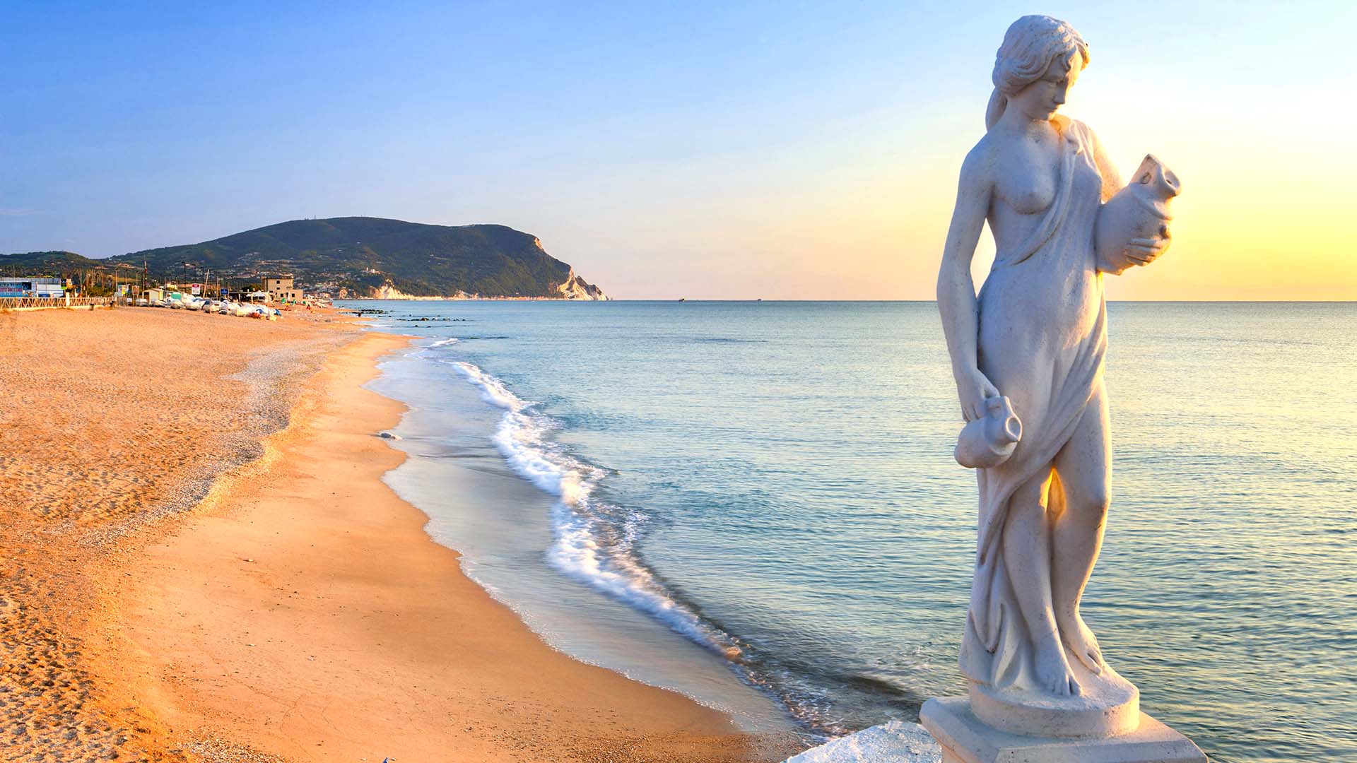 La spiaggia di Numana dominata dal Monte Conero solitaria all'alba.